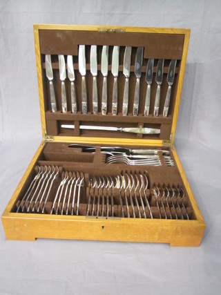 A canteen of silver plated flatware contained in an oak canteen  box
