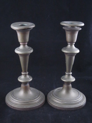 A pair of silver plated candlesticks 8"