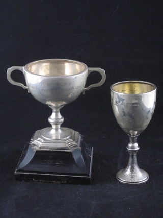 A silver twin handled trophy cup, London 1950 and a silver  goblet shaped trophy cup, London 1969, 9 ozs