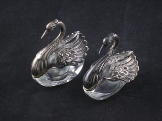A pair of glass and silver salts in the form of swans 2"