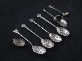 A silver caddy spoon and 4 Eastern spoons
