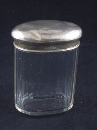 An oval faceted glass pin jar with silver lid 4"