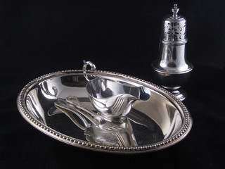 A silver plated entree dish base, silver plated sauce boat, a pair  of fish knives and forks and a sugar castor