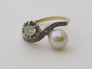 A lady's gold cross-over dress ring set a pearl and diamond