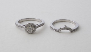 A lady's 18ct white gold wedding band and engagement ring set both set diamonds