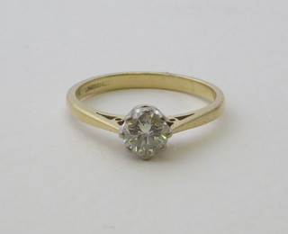 A lady's 18ct gold dress ring set a solitaire diamond