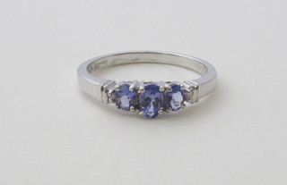 A 14ct white gold dress ring set oval cut blue stones