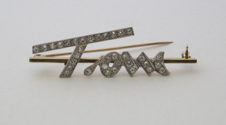 A gold name bar brooch set diamonds in the form of Tom