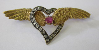 A gold brooch in the form of a winged heart set ruby and  diamonds
