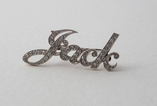 A gold name bar brooch set diamonds in the form of Jack