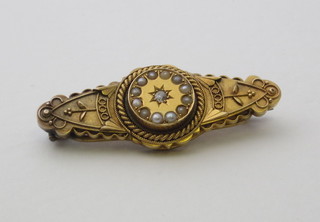 A Victorian 15ct gold brooch set demi-pearls and diamond to the centre