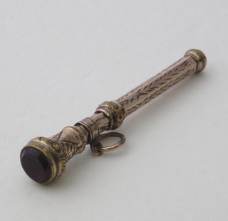 A toothpick contained in a gilt metal case
