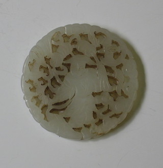 A circular pierced carved section of jade 2"