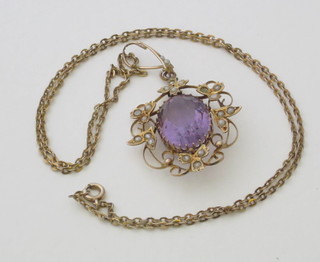 A lady's 9ct gold pendant set an oval cut amethyst supported by pearls, hung on a fine gold chain
