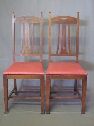 A set of 4 oak Art Nouveau stick and rail back dining chairs