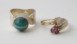 A silver dress ring set a cabouchon cut hardstone and 1 other dress ring