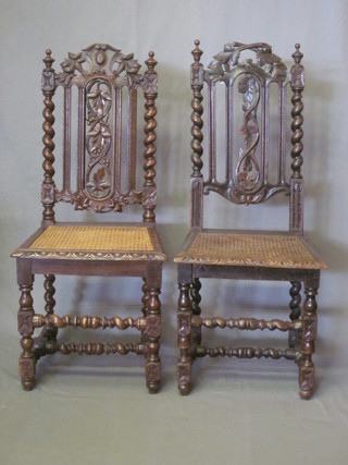A pair of Victorian carved oak Carolean style high back chairs with woven rush seats