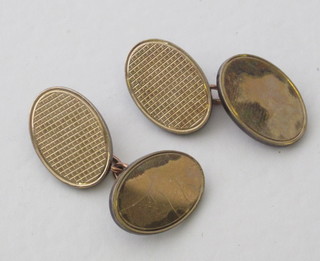 A pair of 9ct gold and silver oval cufflinks