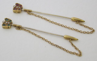 A pair of 18ct gold stick pins in the form of insects, 1 set emerald and diamonds the other rubies and diamonds