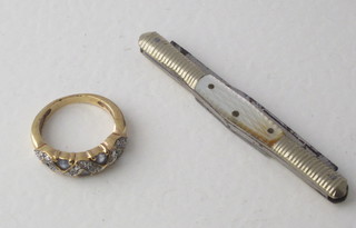 A gilt metal ring and a folding pocket knife