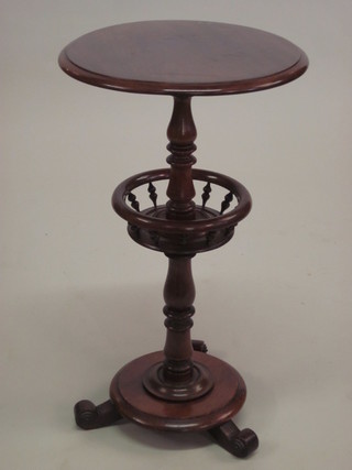 A circular Victorian sewing table, raised on a column with turned basket and base on scroll supports 15"  ILLUSTRATED