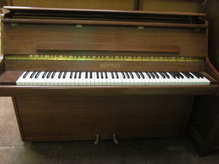 A modern upright piano forte by Bentley No.150200 contained in a teak finished case