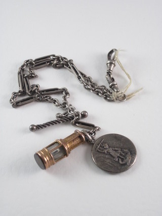 A silver Langtree type watch chain hung a gilt metal charm in  the form of a Davy lamp