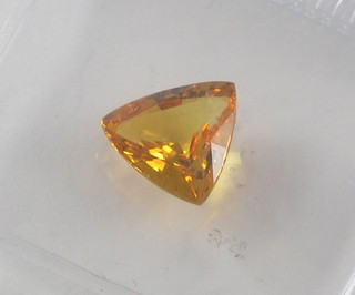 An unmounted trillion cut orange sapphire 2.80ct