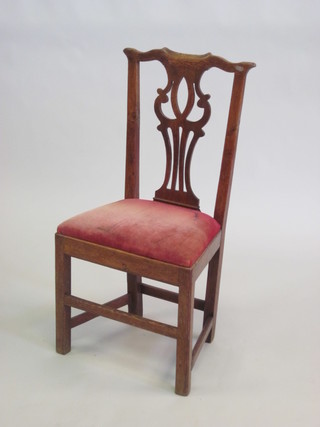 An oak Chippendale style Country chair with pierced vase shaped back, upholstered seat and raised on square supports