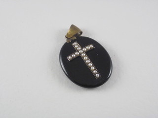 A Victorian oval black enamel mourning locket set demi-pearls
