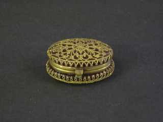 An oval ruby glass and gilt filigree mounted trinket/pill box with hinged lid 2"