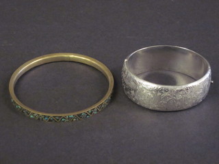 An engraved white metal bracelet and a mosaic patterned bangle