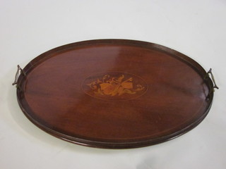 An Edwardian oval inlaid mahogany twin handled tea tray,  decorated musical trophies 25"