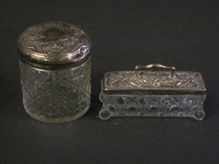 A cylindrical cut glass dressing table jar with silver lid 3" and a rectangular ditto 4"
