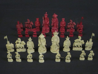 An Oriental red and white carved ivory chess set