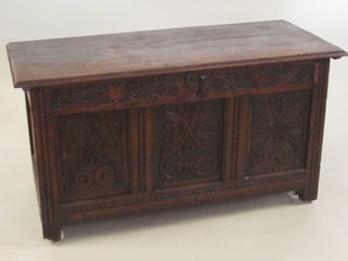 An 18th Century carved oak coffer of panelled construction with hinged lid 51"