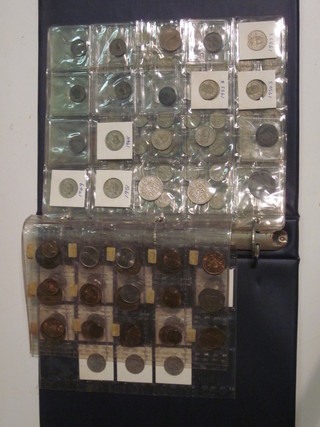 A blue plastic ring binder album of various coins