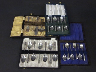 A set of 6 silver plated coffee spoons with caddy spoon, and a set  of 6 silver plated Old English pattern coffee spoons and a 4 piece  silver plated tea implement set, all cased