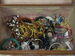 An attache case containing a collection of costume jewellery