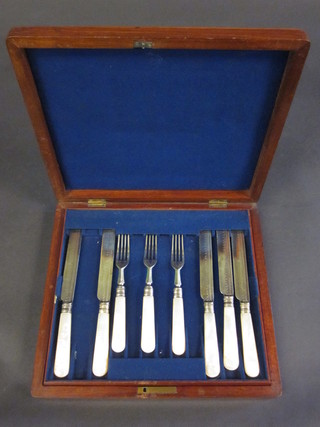 A set of Victorian silver plated fruit knives and forks with mother  of pearl handles, comprising 11 knives and 9 forks contained in a  mahogany canteen box