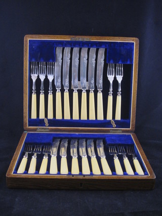 A set of 12 silver plated fish knives and forks contained in an oak canteen box