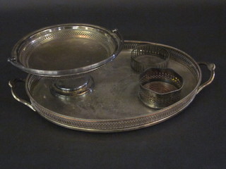 An oval silver plated tea tray, a silver plated cake basket with swing handle and a pair of wine coasters