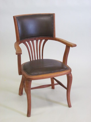 An Edwardian oak tub back office chair