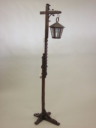 A 1930's rustic style oak adjustable standard lamp