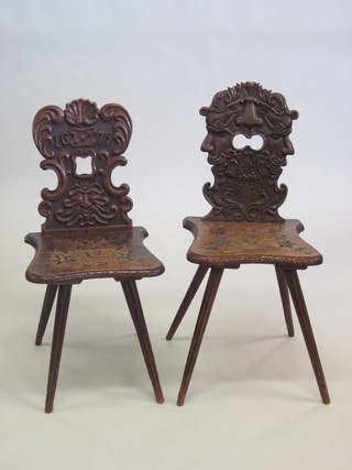 A pair of 19th Century Continental carved and pierced oak hall  chairs raised on outswept supports