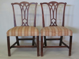 A pair of 19th Century mahogany Chippendale style dining chairs with vase shaped slat backs and over stuffed seats