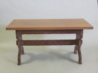 A Waring & Gillows honey oak Arts & Crafts style rectangular  refectory table with H framed stretcher, raised on standard end  supports