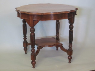 A Victorian circular walnut occasional table with pie crust edge, raised on turned and reeded supports with undertier 30"