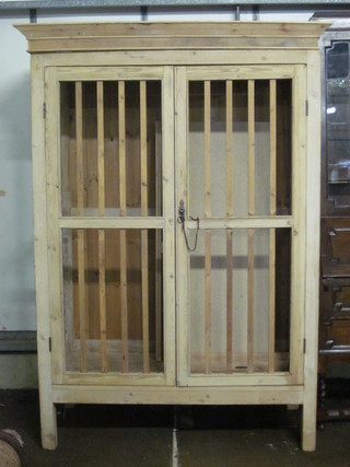 A 19th Century pine game cabinet enclosed by panelled doors  52"