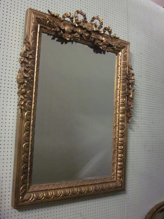 A pair of rectangular bevelled plate wall mirrors contained in decorative gilt frames with garlands to the top 46" x 30"